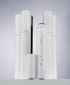 Set of white cosmetic products with visible branding on a gray background