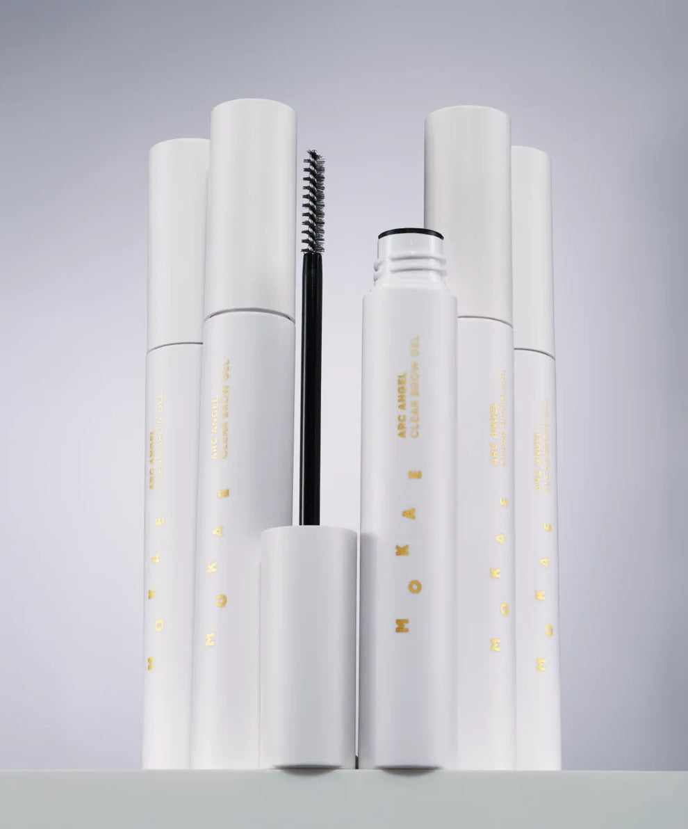 Set of white cosmetic products with visible branding on a gray background