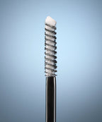 Eyebrow brush with bristle head on a gradient blue background