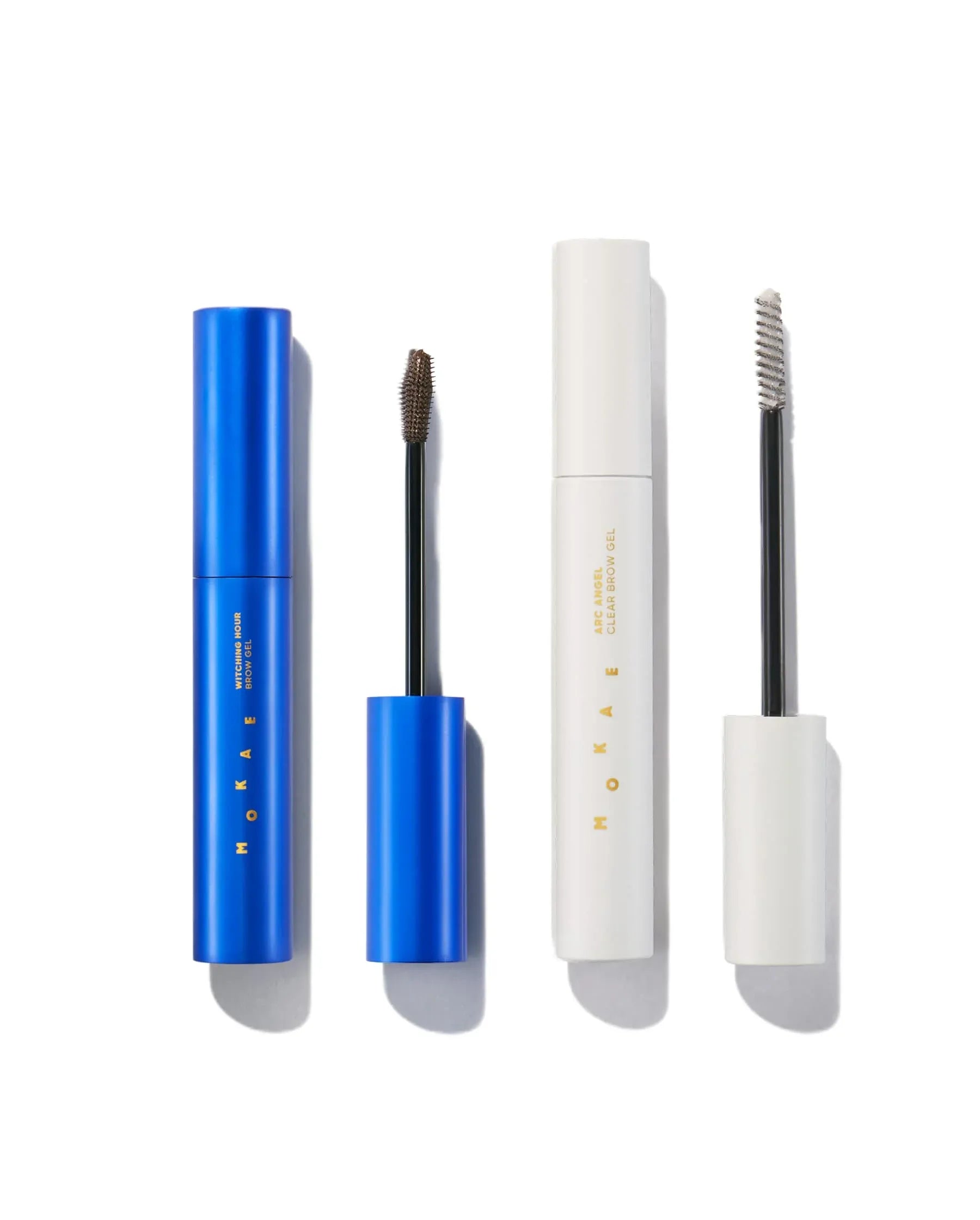 Set of cosmetic products including a blue and white mascara, a white eyeliner, and a white brow product on a white background.
